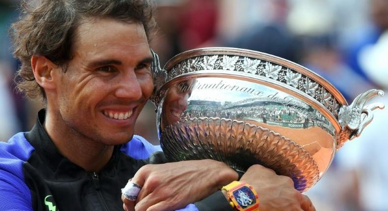 Spain's Rafael Nadal poses with the trophy after winning his 10th French Open title on June 11, 2017