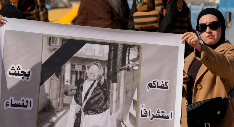 Demonstrators carry a poster with a picture of Tiba Ali, a YouTube star who was recently killed by her father, in Diwaniya, Iraq, Sunday, February 5, 2023.AP Photo/Hadi Mizban