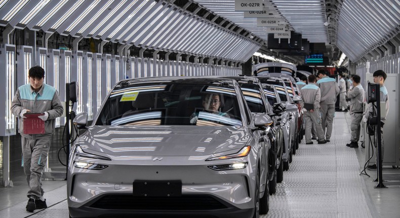 Workers from Chinese EV company NIO inspect vehicles at the company's manufacturing hub in Hefei, China.Kevin Frayer/Getty Images