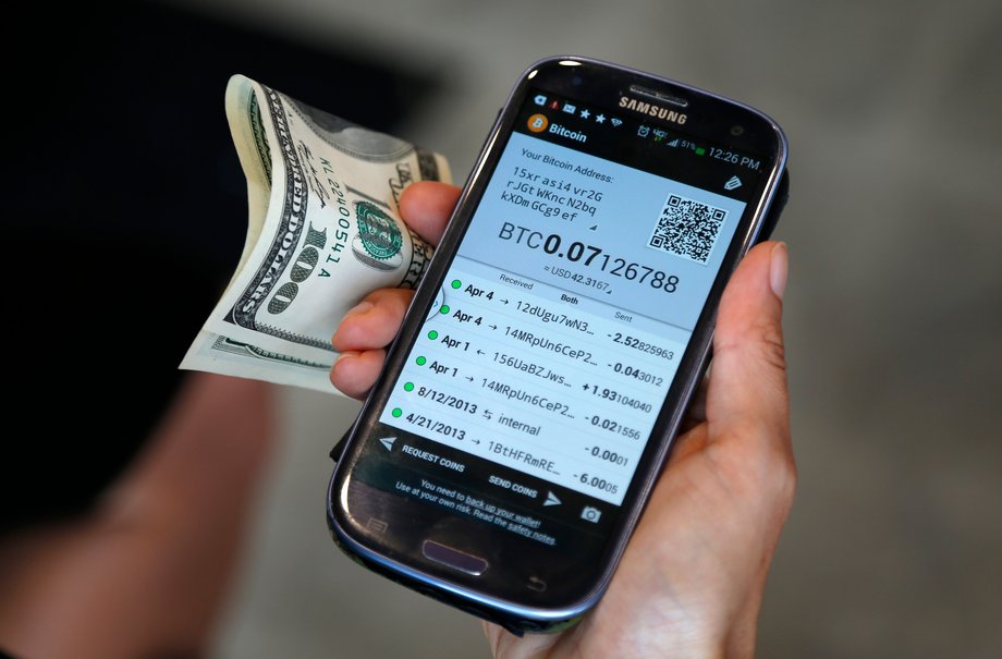 Dana Byerlee, 33, of Santa Monica, prepares to use one of Southern California's first two bitcoin-to-cash ATMs, in Locali Conscious Convenience store in Venice, Los Angeles, California, June 21, 2014.