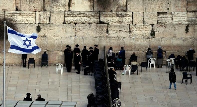 Ultra-Orthodox Jewish men (L) and women (R) pray in different sections of the Western Wall in Jerusalem's Old City on February 2, 2016