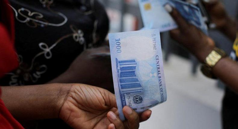 Traders, buyers adopt online cash transfer as naira scarcity lingers. [reuters]