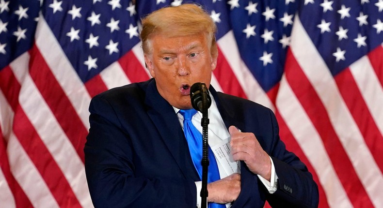 President Donald Trump reaches into his suit during a news conference where he prematurely declared victory in the election on November 4, 2020 with ballots still being counted in many battleground states.Evan Vucci/AP