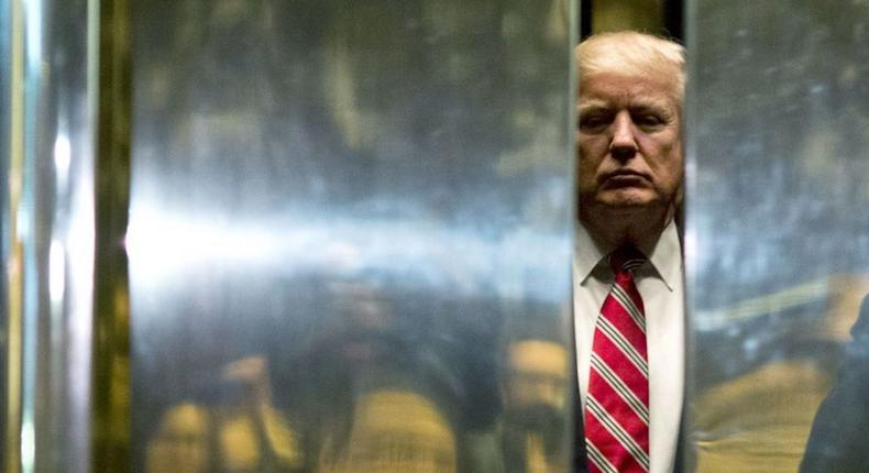 Then President-elect Donald Trump boards the elevator at Trump Tower in New York City.
