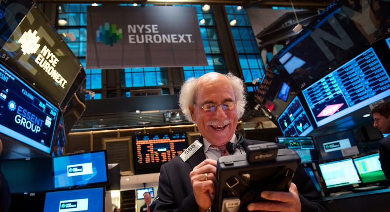 Trader Peter Tuchman smiles as he works on the floor of the New York Stock Exchange after the market opening in New York, December 23, 2013.