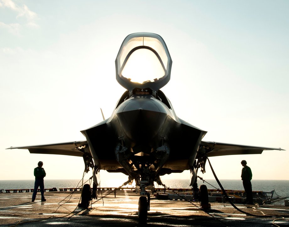 The flight deck crew secures an F-35B Lighting II aircraft aboard the amphibious assault ship USS Wasp.