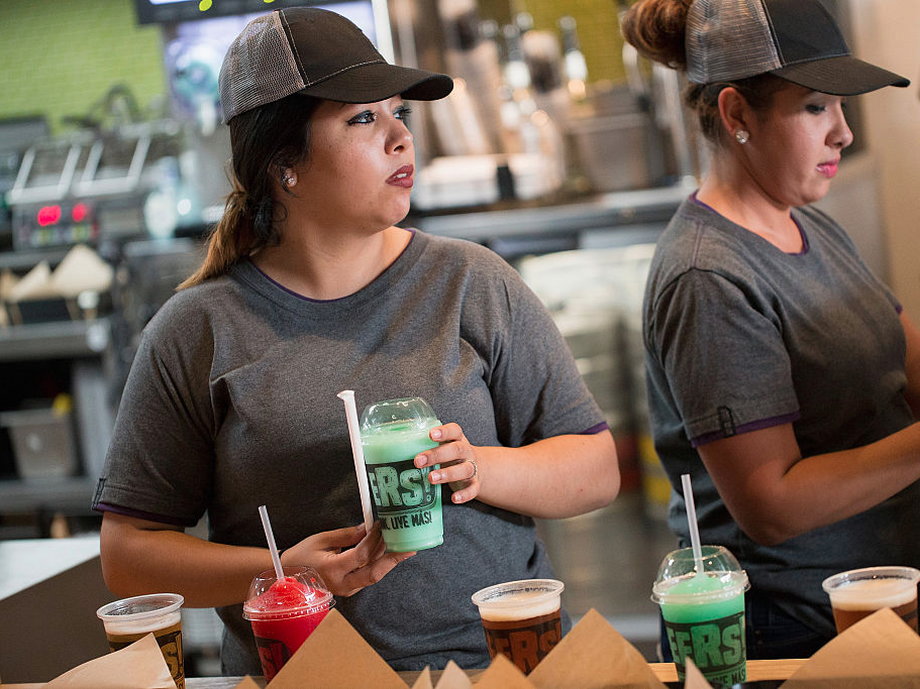 A worker serves a twisted Freeze at a Taco Bell Cantina restaurant on September 22, 2015 in Chicago, Illinois.