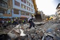 A U.S. rescue team member walks above debris in search for survivors after the earthquake in Kathmandu