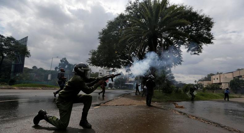 A riot policeman lobs a teargas canister to disperse supporters of the opposition Coalition for Reforms and Democracy (CORD), during a protest at the premises hosting the headquarters of Independent Electoral and Boundaries Commission (IEBC) to demand the disbandment of the electoral body ahead of next year's election in Nairobi, Kenya, May 9, 2016. 