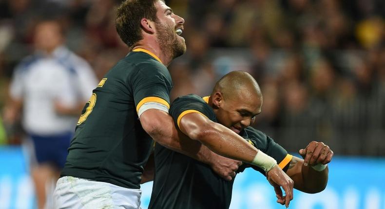 Springbok winger Cornal Hendricks (R) celebrates scoring a try against New Zealand in a 2014 Rugby Championship match in Wellington
