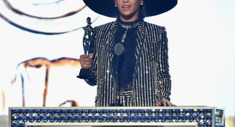 Beyonce receives the 2016 CFDA Fashion Icon Award in a shimmering Givenchy suit and hat