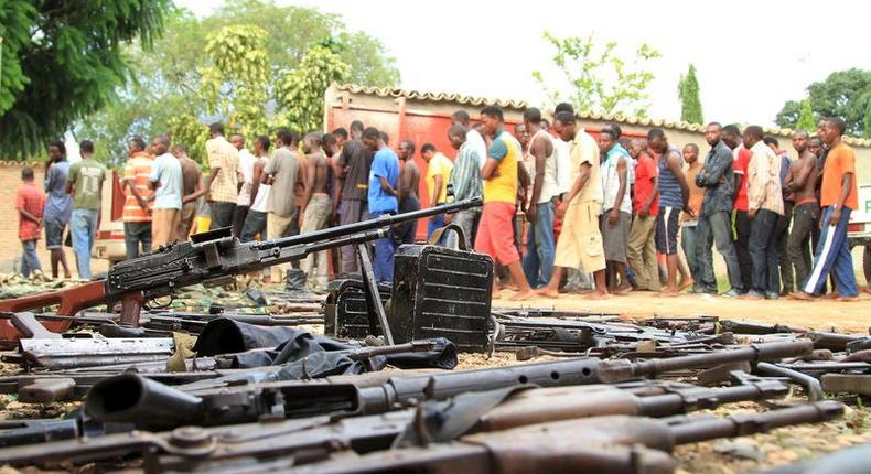 Suspected fighters are paraded before the media by Burundian police near a recovered cache of weapons after clashes in the capital Bujumbura, Burundi December 12, 2015. REUTERS/Jean Pierre Aime Harerimana