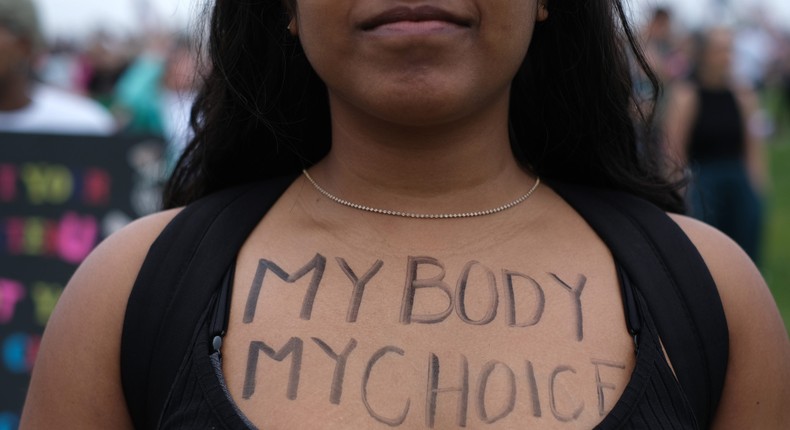 An abortion rights demonstrator has the words My Body My Choice written on her front as she gathers near the Washington Monument during a nationwide rally in support of abortion rights in Washington, D.C.