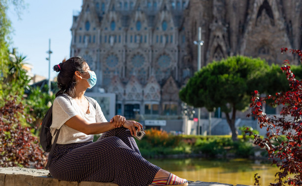 Kobieta w maseczce przy Sagrada Familia w Barcelonie