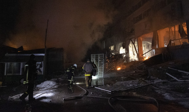 Ukraińscy ratownicy i policjanci pracują na miejscu ataku dronów w Charkowie, w północno-wschodniej Ukrainie, 30 stycznia 2024 r.