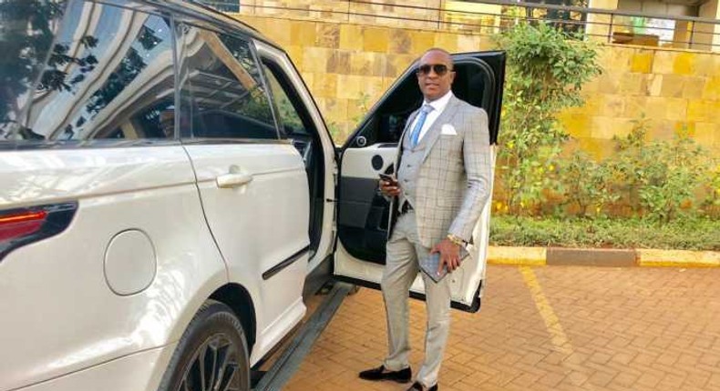 File image of controversial politician Steve Mbogo standing next to one of the high-end vehicles in his fleet DCI has impounded one of his Range Rovers