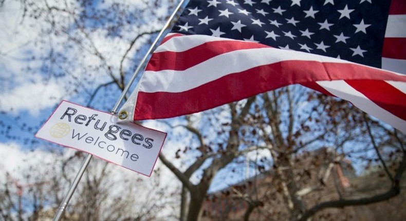 A protester holds a sign near the White House to protest President Donald Trump's travel ban on six Muslim countries on March 11, 2017