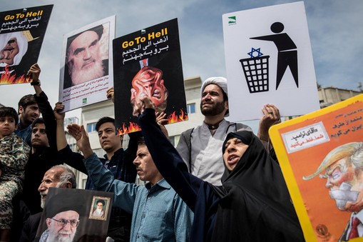 Iranians shout slogans during a protest against President Donald Trump's decision to walk out of a 2