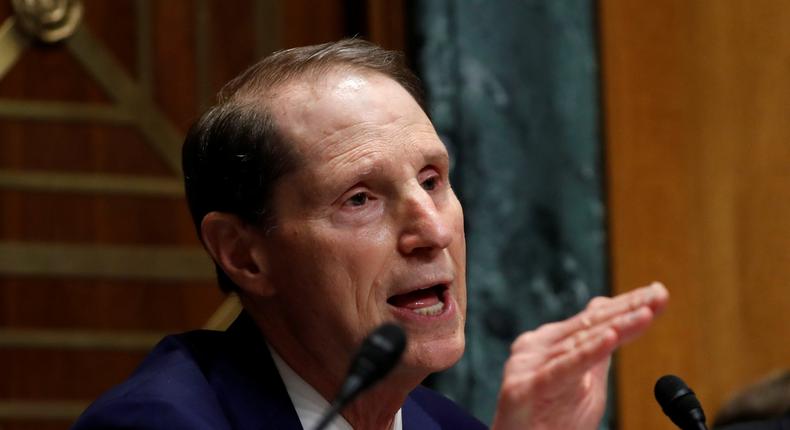 Senator Ron Wyden, L, (D-OR) questions Commerce Secretary Wilbur Ross as Sen. Orrin Hatch, R, (R-UT) listens on during a Senate Finance hearing on