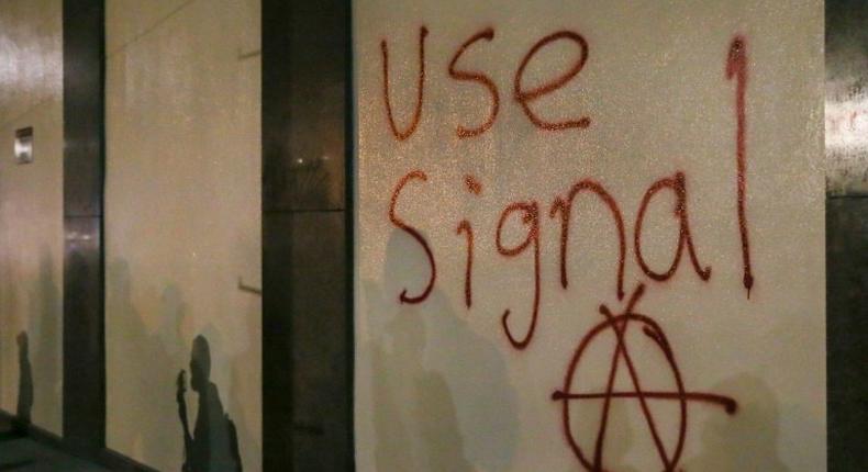 Grafitti urging people to use Signal, a highly-encrypted messaging app, is spray-painted on a wall during a protest in Berkeley, California