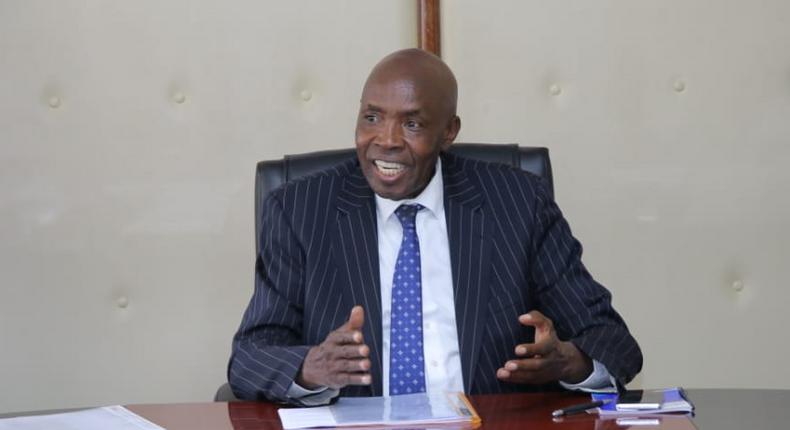 Ezekiel Machogu chairs a meeting in his office