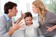 Couple fighting in front of child