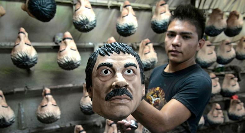 A worker with a latex mask of two-time prison escapee and top drug lord Joaquin El Chapo Guzman, at the plant in Cuernavaca, Mexico, October 13, 2015.