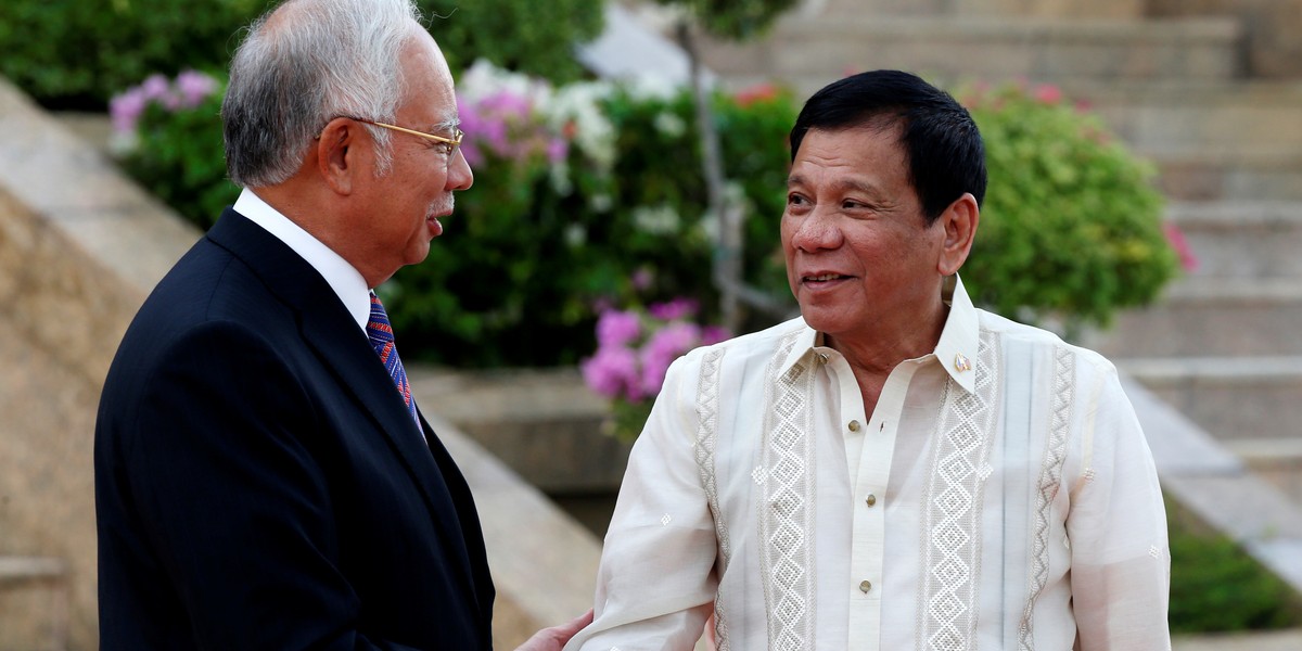 Philippines President Rodrigo Duterte and Malaysia's Prime Minister Najib Razak shake hands before a welcome ceremony in Putrajaya, Malaysia, November 10, 2016.