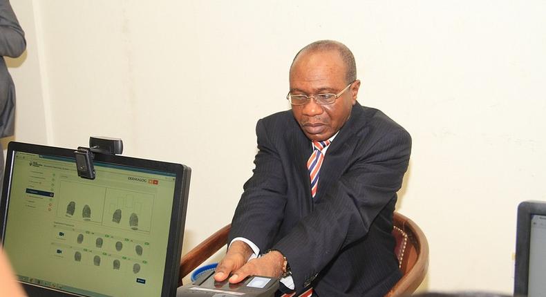 Godwin Emefiele, Governor of the Central Bank of Nigeria during a biometric exercise