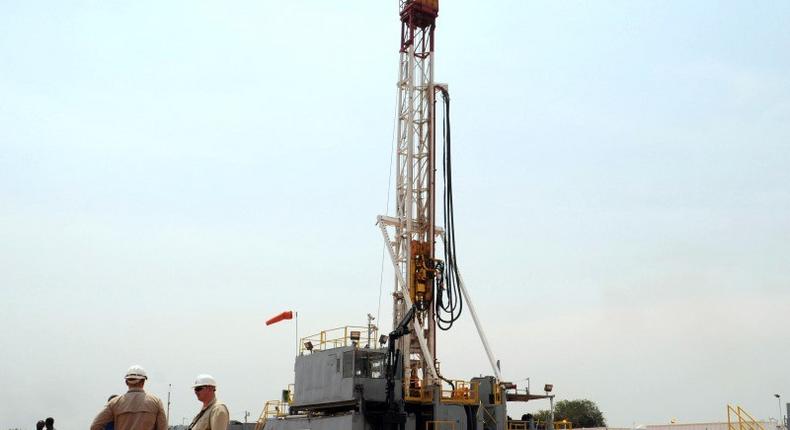 Workers are seen at an oil exploration site in Bulisa district approximately 244km (152 miles) North-West of Kampala January 20, 2012. REUTERS/Stringer