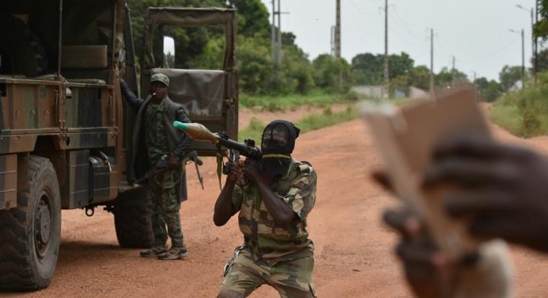 A mutinous soldier holds a RPG rocket launcher inside a military camp in the Ivory Coast's central second city Bouake, on May 15, 2017