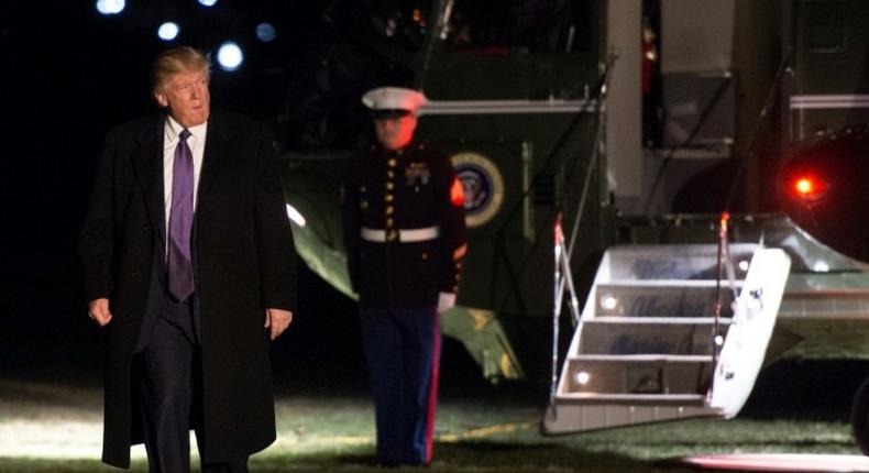 US President Donald Trump walks away from Marine One at the White House as he returns from his weekend trip to Mar-a-Lago