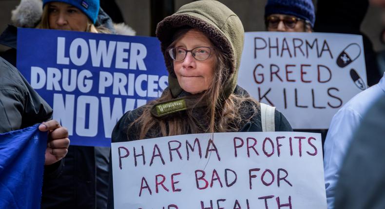 A woman protests Big Pharma, calling for lower drug prices.
