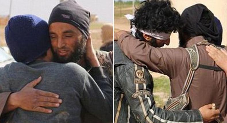 An ISIS executioner hugs his two victims