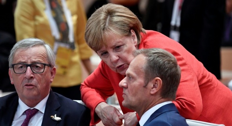 EU President Donald Tusk (R) is urging G20 leaders to be more determined to fight against people smugglers in the migrant crisis