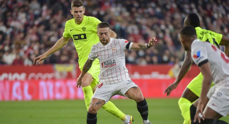 Sevilla's Papu Gomez (C) scored the opener against Elche CF at the Ramon Sanchez Pizjuan stadium in Seville. Creator: CRISTINA QUICLER