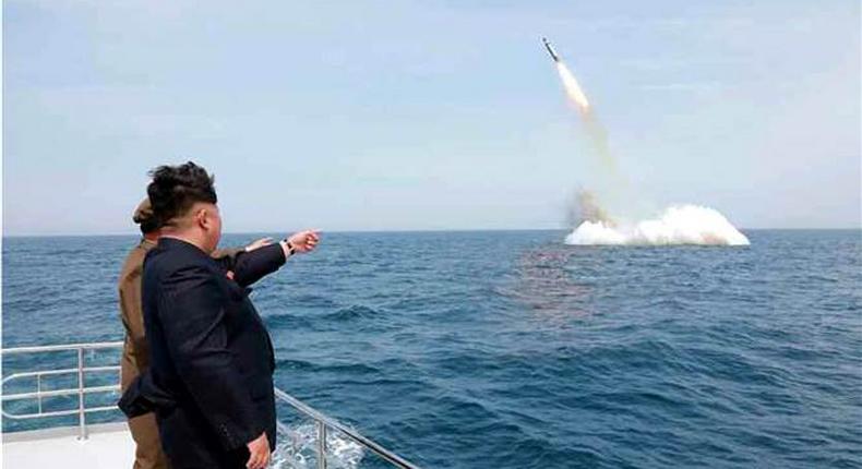 An image obtained by Yonhap News Agency shows North Korean leader Kim Jong Un pointing at a ballistic missile believed to have been launched from underwater on Saturday. 