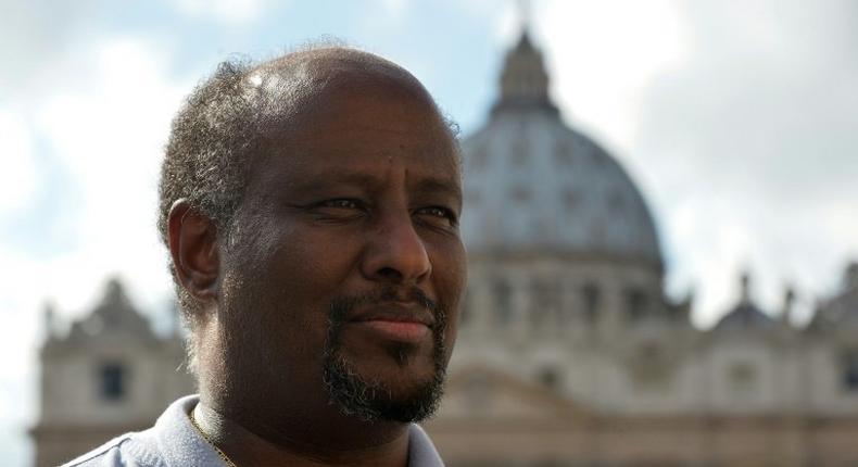Eritrean priest Mussie Zerai poses in front of Saint Peter's basilica on October 4, 2015 in Vatican