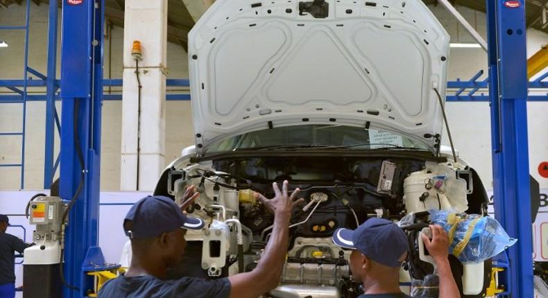 Technicians work on a Polo Vivo at a new assembly plant in Kenya's Thika industrial area, on December 21, 2016