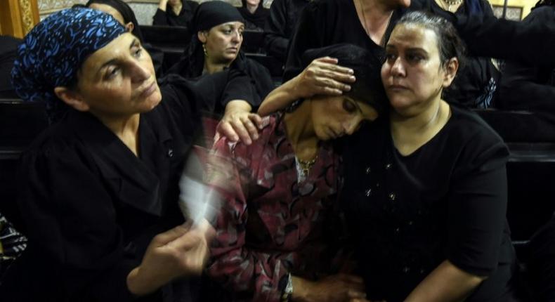 Relatives of killed Coptic Christians grieve during a funeral at Abu Garnous Cathedral in the north Minya town of Maghagha, on May 26, 2017