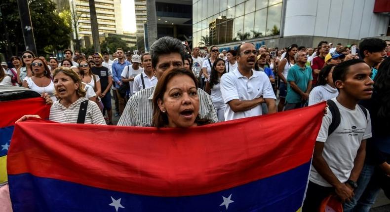 Venezuelan opposition activists march during a protest against President Nicolas Maduro's government, in Caracas on April 15, 2017