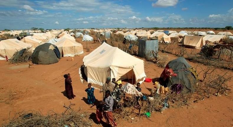 Refugees stand outside their tent at the Ifo Extension refugee camp in Dadaab, near the Kenya-Somalia border in Garissa County, Kenya October 19, 2011. 