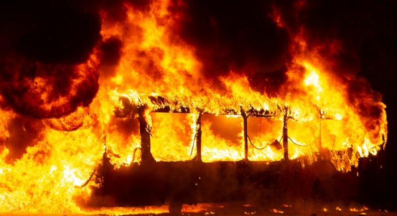 A bus burns in downtown Santiago. Protests over metro fare increases escalated into clashes with riot police, with subway stations torched and vandalised