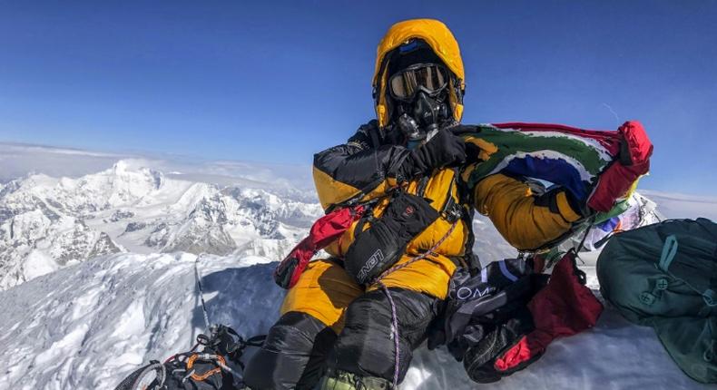 Saray Khumalo poses with a South African flag on May 16, 2019, after becoming the first black African woman to climb Mount Everest