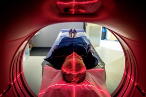 Patient lying inside a medical scanner in hospital