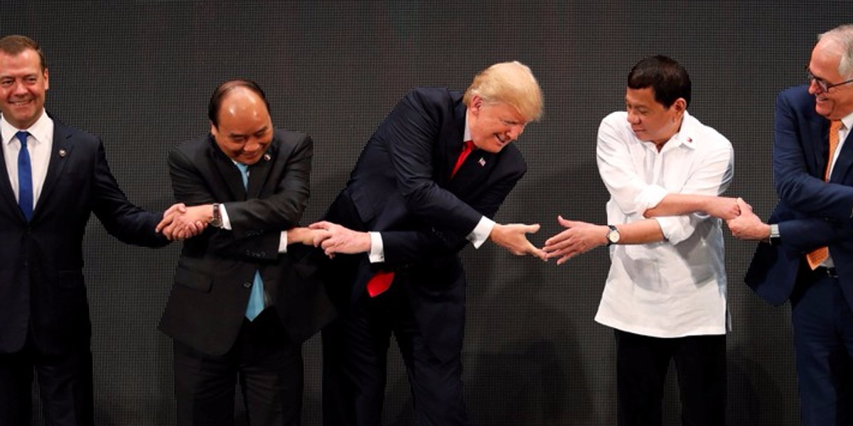 The internet is loving Trump's latest awkward handshake from his Asia trip