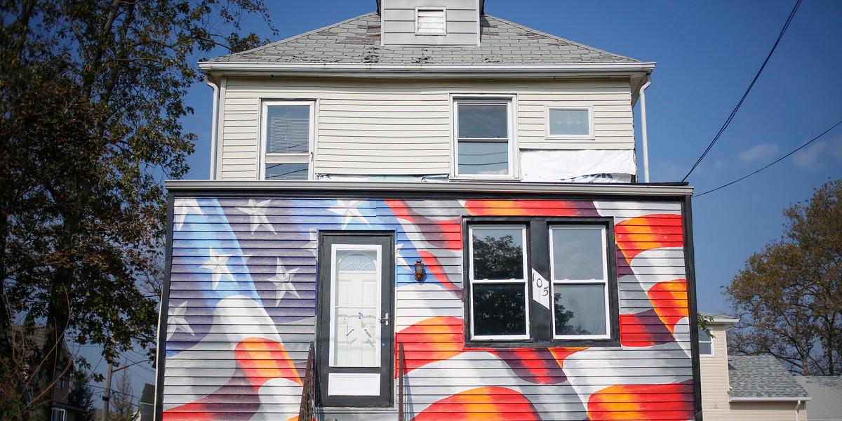 A home that was damaged by Hurricane Sandy is seen painted with an U.S. flag mural at its entrance in the borough of Staten Island, New York, October 4, 2013.