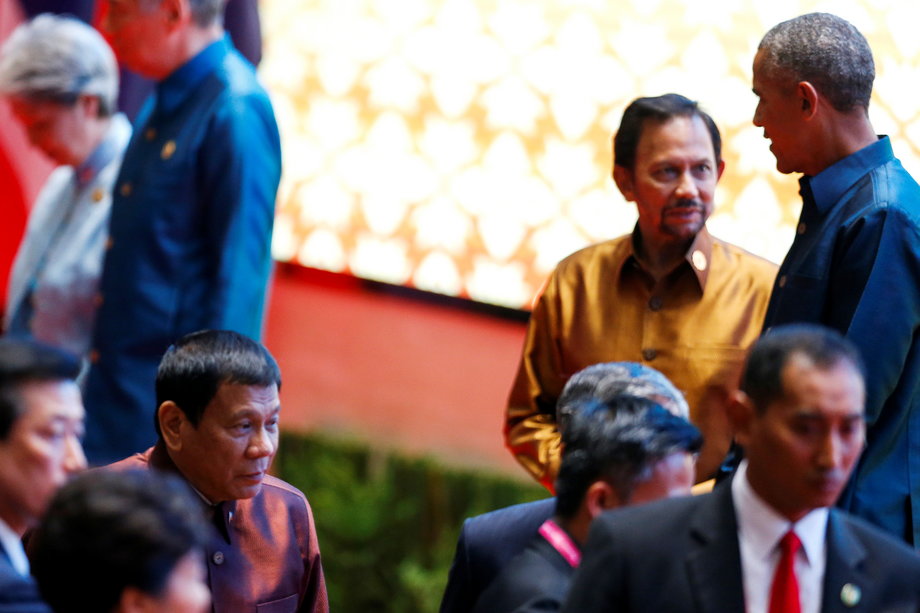 Philippine President Rodrigo Duterte arrives at the ASEAN Summit family photo while US President Barack Obama chats with the Sultan of Brunei Hassanal Bolkiah in Vientiane, Laos, September 7, 2016.