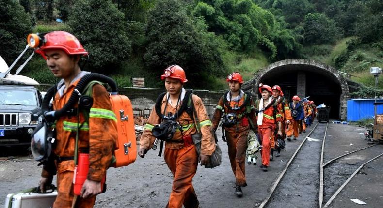 Rescuers ar Jinshangou Coal Mine in Chongqing -- accidents at mines and steel foundries were singled out for their poor safety records