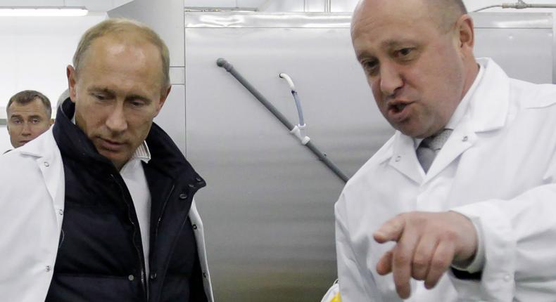 Businessman Yevgeny Prigozhin shows Russian President Vladimir Putin his school lunch factory outside Saint Petersburg on September 20, 2010.